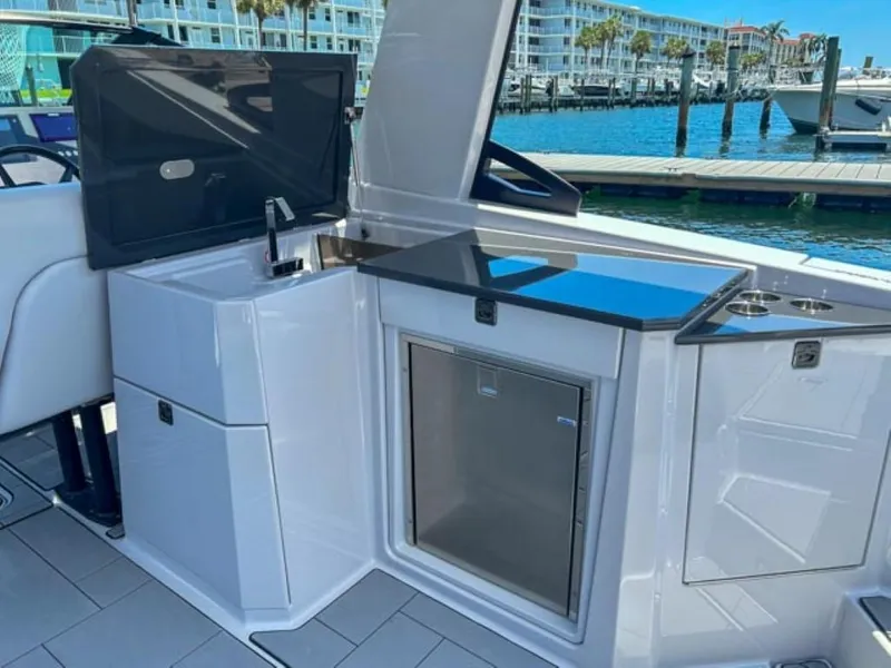 Slide: The Image of 2020 Aviara AV32 OB boat interior with kitchenette and waterfront view. - 15