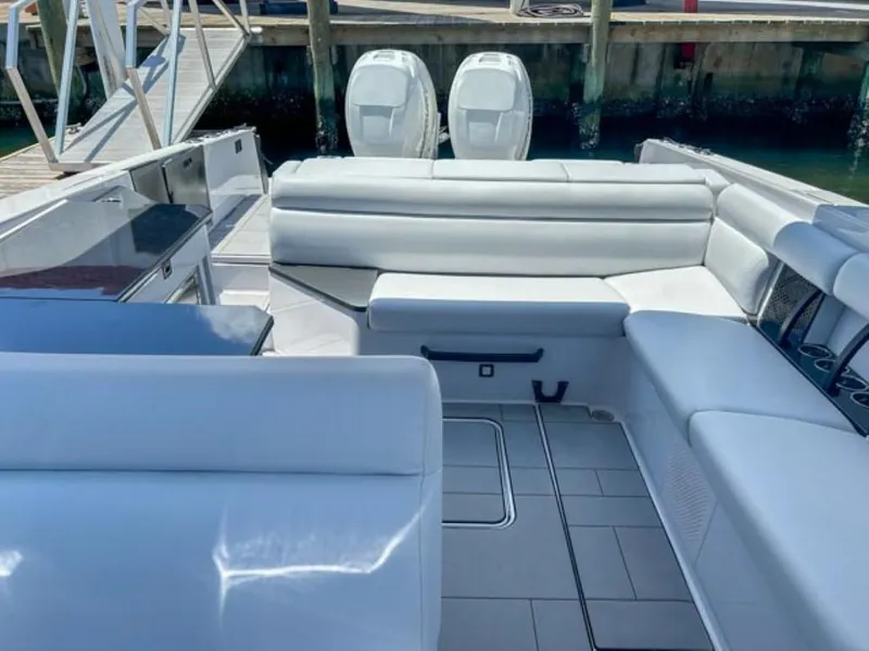Slide: The Image of 2020 Aviara AV32 OB boat interior with white seating and twin outboard motors. - 17