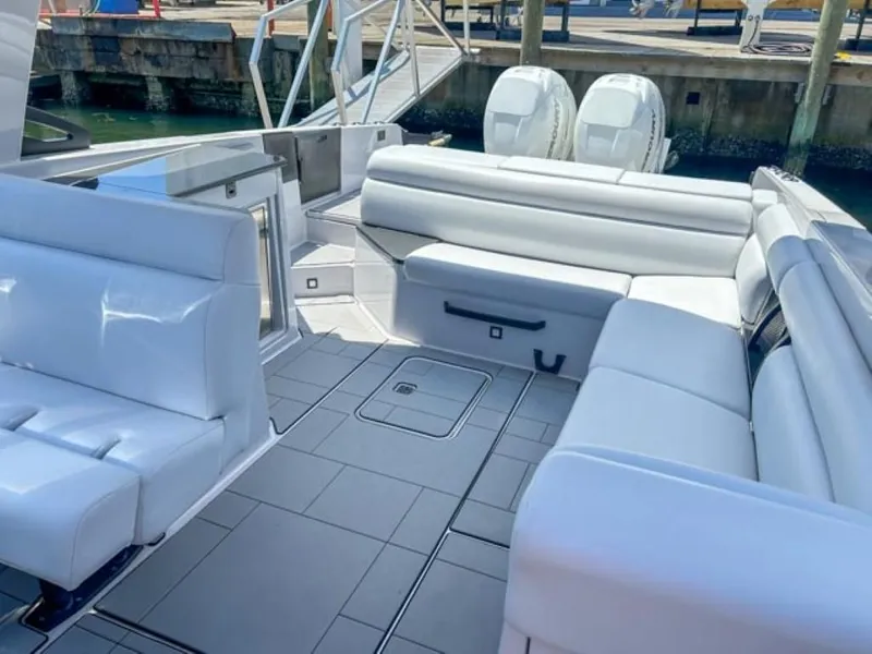 Slide: The Image of 2020 Aviara AV32 OB boat with spacious white leather seating and twin outboard engines. - 16
