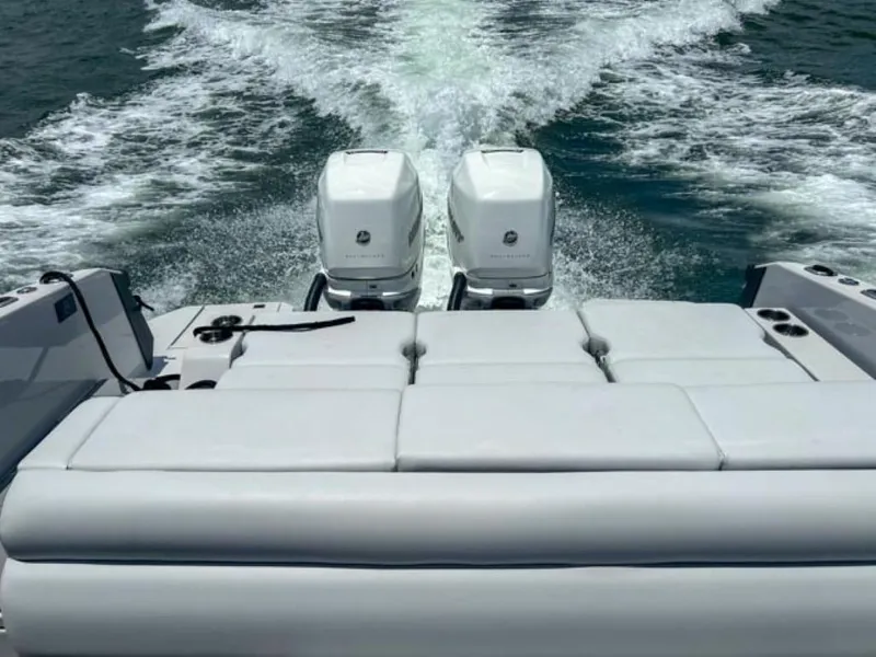 Slide: The Image of 2020 Aviara AV32 OB boat with twin outboard engines cruising on water. - 19
