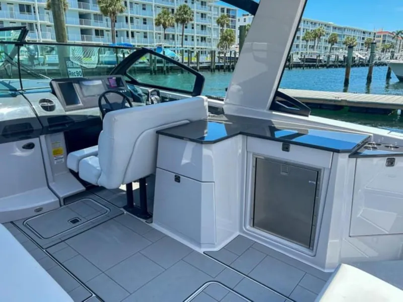 Slide: The Image of 2020 Aviara AV32 OB boat interior with helm, seating, and waterfront view. - 14