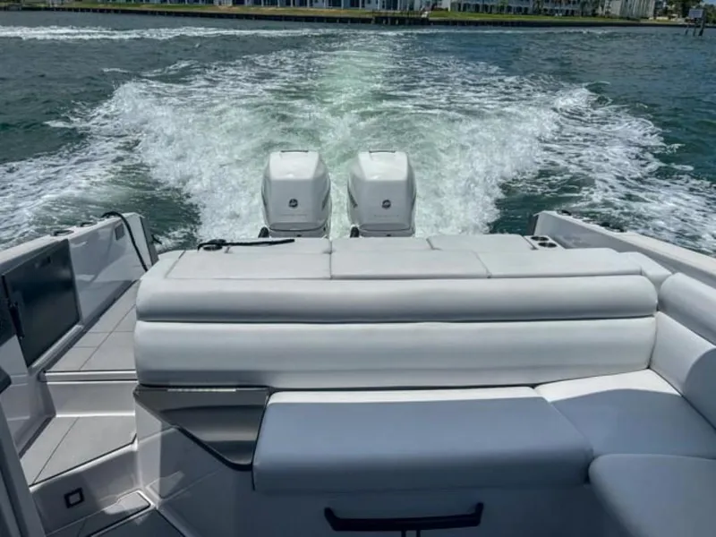 Slide: The Image of 2020 Aviara AV32 OB boat with twin outboard engines cruising on water. - 18