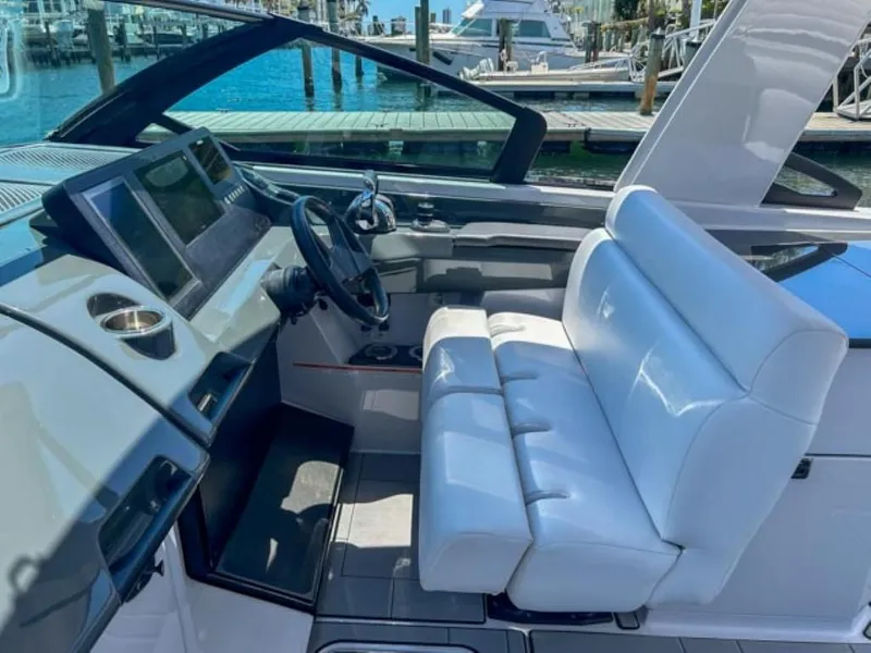 Slide: The Image of 2020 Aviara AV32 OB boat cockpit with white seating and modern dashboard. - 13