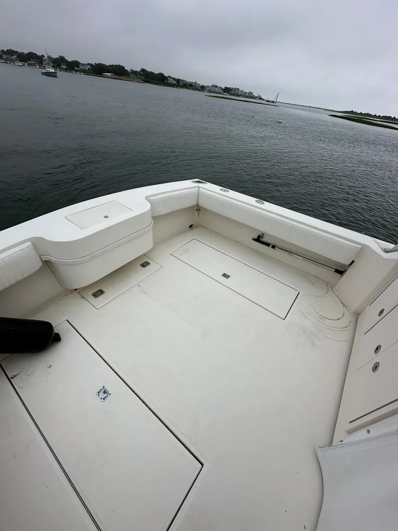 Slide: The Image of 2006 Carolina Classic 28FT boat with spacious deck on calm waters. - 10