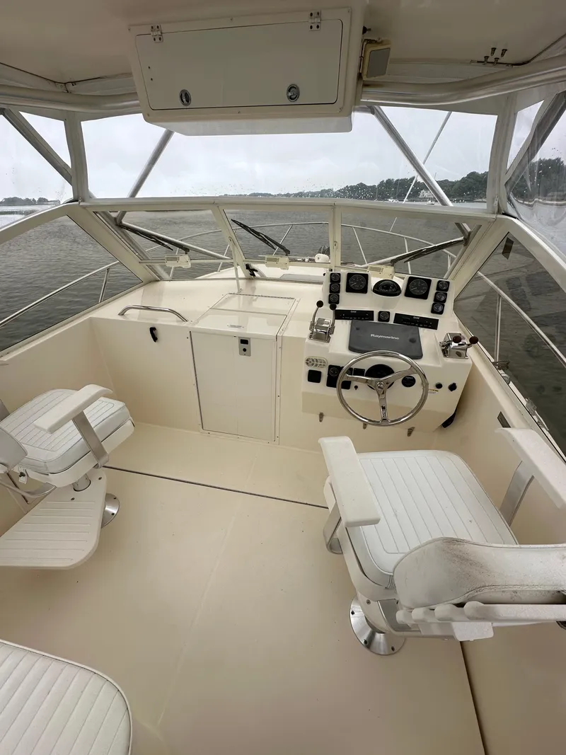 Slide: The Image of 2006 Carolina Classic 28FT boat interior with helm and seating. - 2