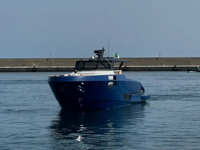 Slide: The Image of 2025 Aicon Audace 50 yacht in a harbor, featuring sleek blue design. - 15