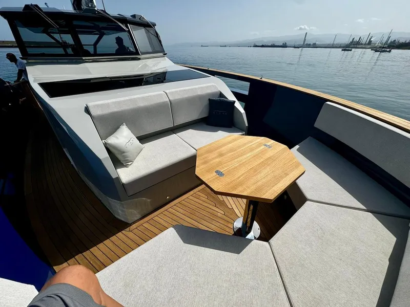 Slide: The Image of 2025 Aicon Audace 50 yacht with elegant deck seating and wooden table. - 36