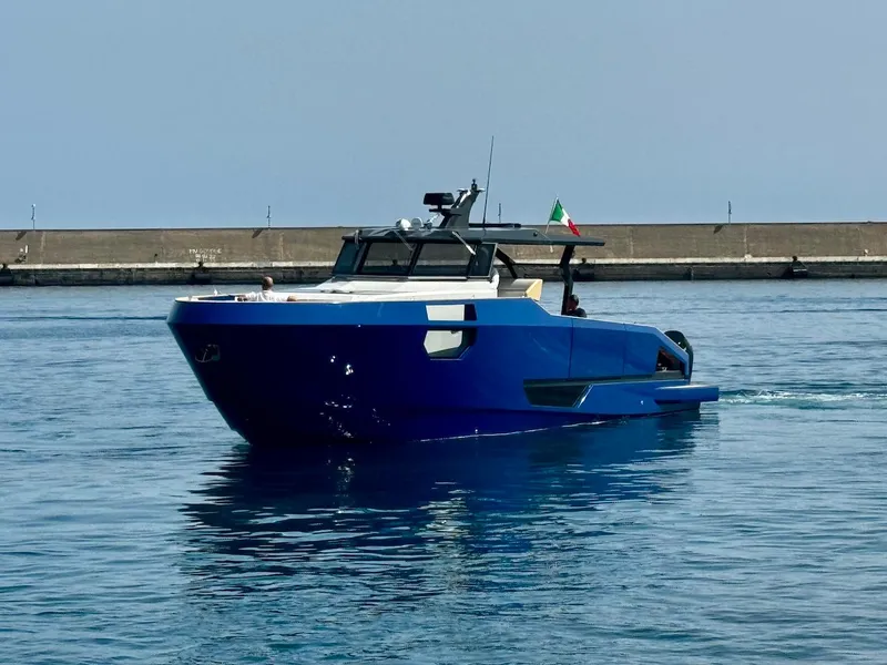 Slide: The Image of Aicon Audace 50 yacht, 2025 model, cruising in calm waters near a concrete pier. - 16