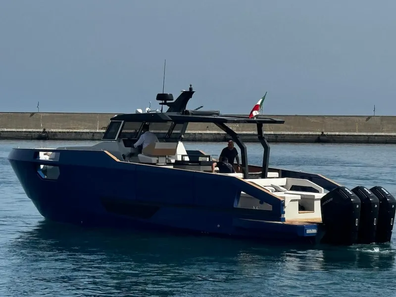 Slide: The Image of Aicon Audace 50 yacht, 2025 model, cruising in calm waters near a breakwater. - 25
