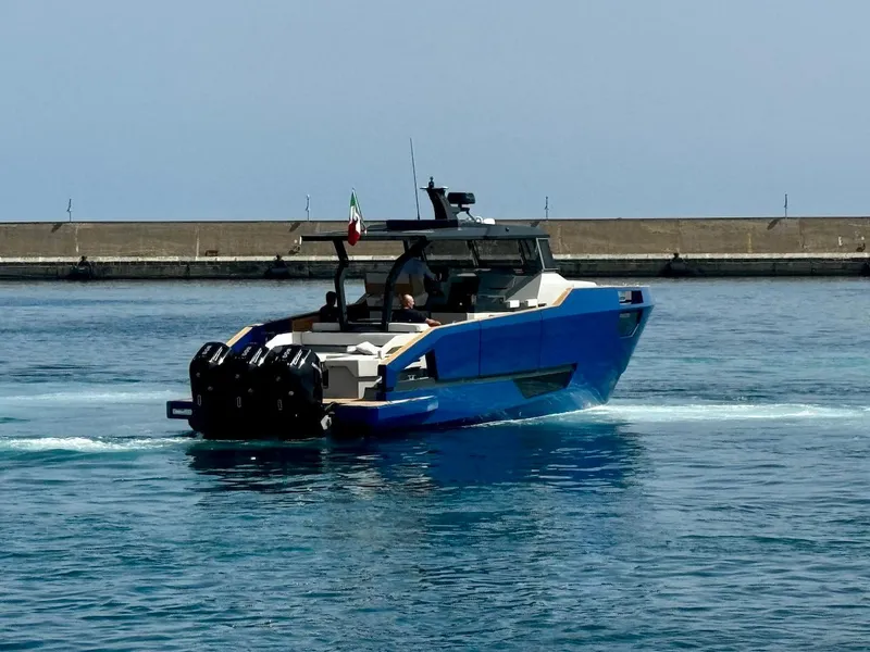 Slide: The Image of Aicon Audace 50 yacht, 2025 model, cruising in calm waters near a breakwater. - 28