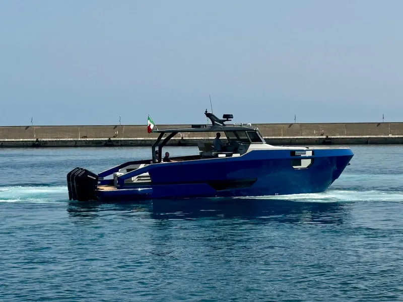Slide: The Image of Aicon Audace 50 yacht, 2025 model, cruising in a harbor with a clear blue sky. - 30
