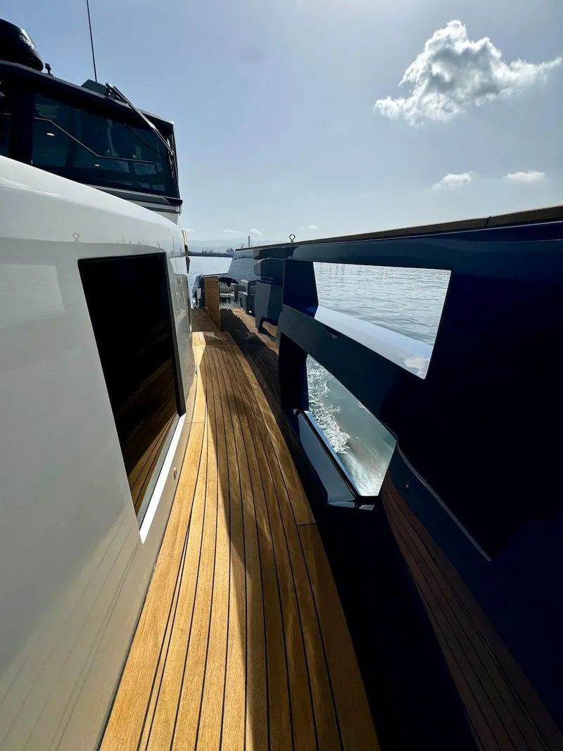 Slide: The Image of 2025 Aicon Audace 50 yacht with sleek design and wooden deck, cruising on a sunny day. - 45