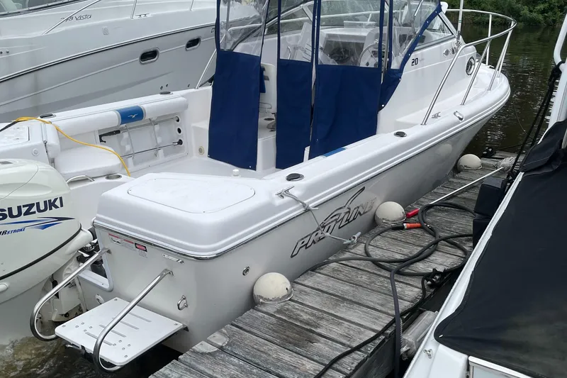Slide: The Image of 2015 Pro-Line 20 Express Cuddy boat docked, featuring Suzuki outboard motor. - 1
