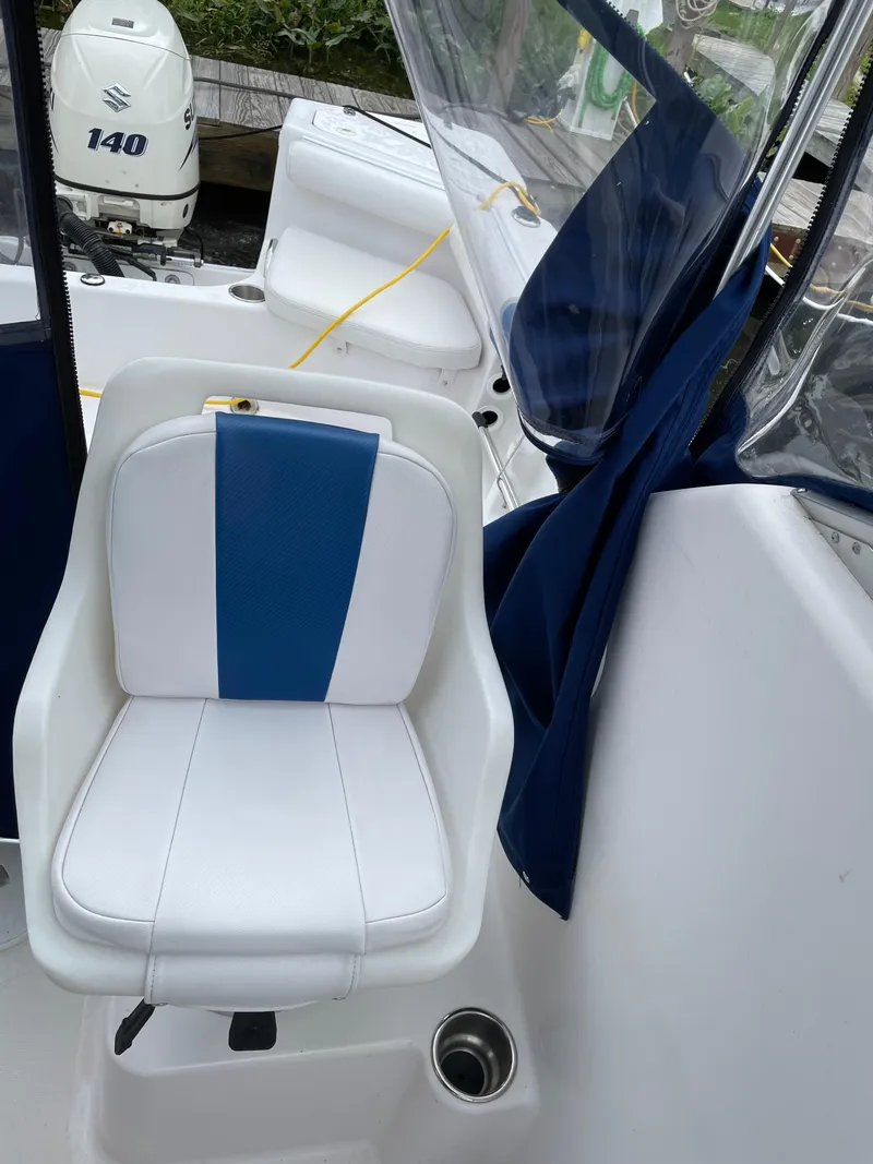 Slide: The Image of 2015 Pro-Line 20 Express Cuddy boat interior with white and blue seating. - 10