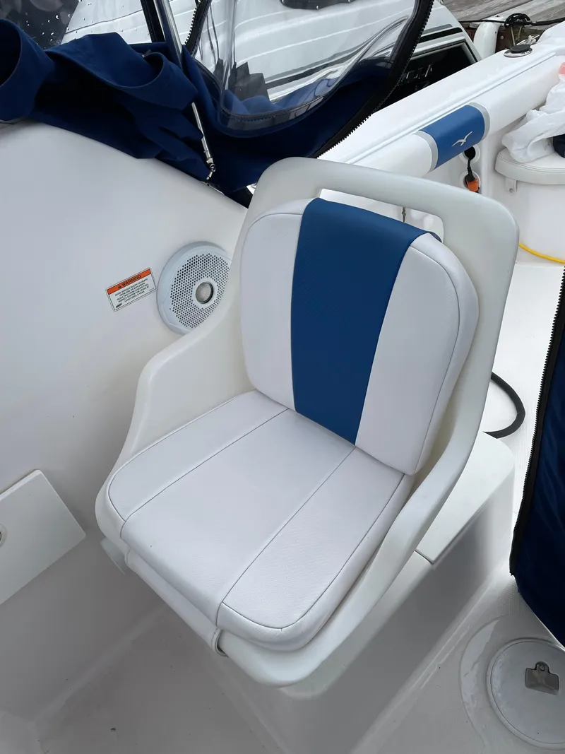 Slide: The Image of 2015 Pro-Line 20 Express Cuddy boat seat with blue and white upholstery. - 18