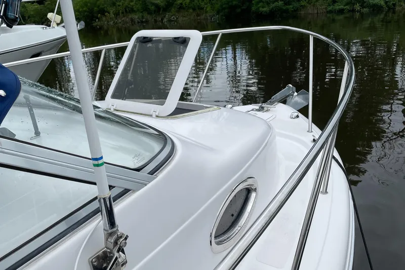 Slide: The Image of 2015 Pro-Line 20 Express Cuddy boat on calm water. - 2