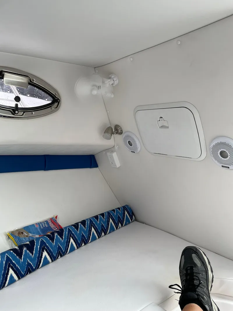 Slide: The Image of Interior of 2015 Pro-Line 20 Express Cuddy cabin with seating and porthole. - 20