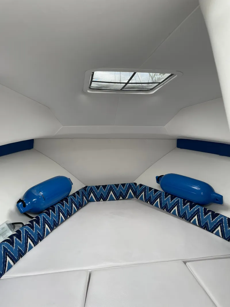 Slide: The Image of Interior cabin of 2015 Pro-Line 20 Express Cuddy with blue accents and skylight. - 9