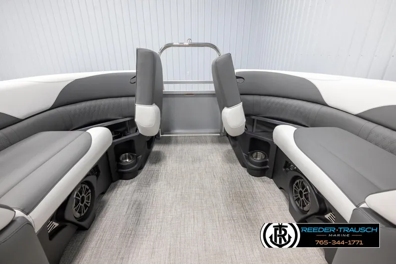 Slide: The Image of 2024 Avalon LSZ QL boat interior with gray and white seating, cup holders, and speakers. - 16