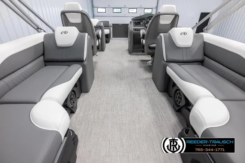 Slide: The Image of 2024 Avalon LSZ QL boat interior with gray and white seating, Reeder-Trausch Marine logo. - 17