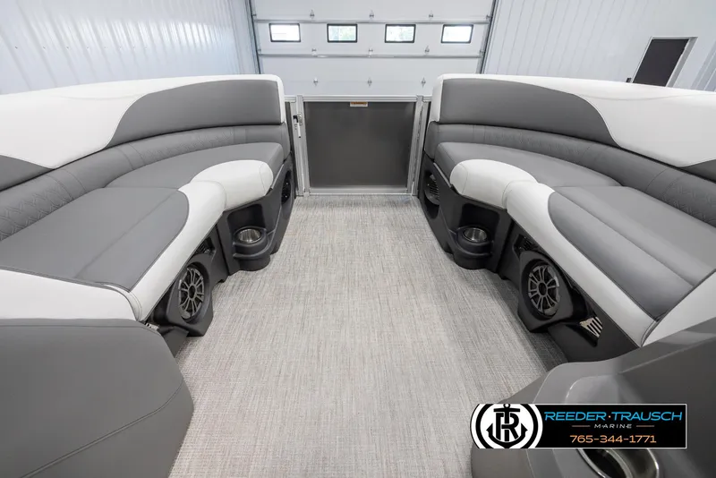 Slide: The Image of 2024 Avalon LSZ QL boat interior with gray and white seating, cup holders, and speakers. - 19