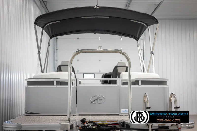 Slide: The Image of 2024 Avalon LSZ QL pontoon boat with canopy in a storage facility. - 7