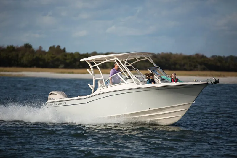 The Image of 2025 Grady-White Freedom 235 boat cruising on water with passengers. - 1
