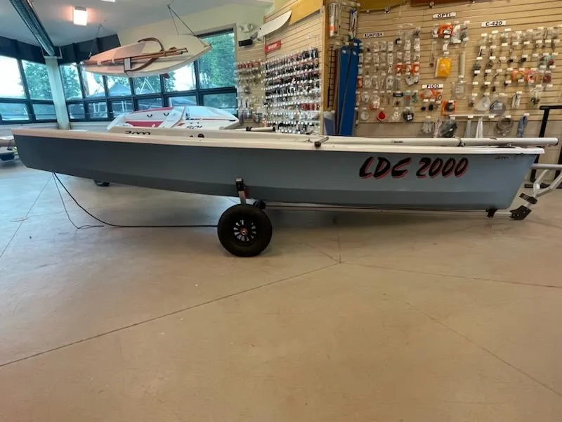 Slide: The Image of 2013 Dinghy LDC 2000 sailboat displayed in a showroom. - 2