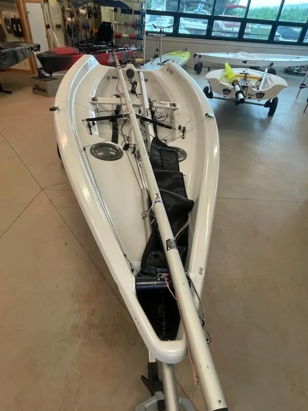 Slide: The Image of 2013 Dinghy LDC 2000 sailboat in indoor storage, mast and rigging visible. - 3