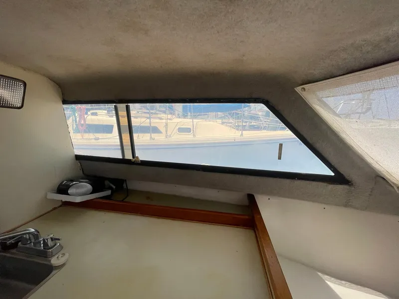 Slide: The Image of Interior view of 1976 Allmand 25 Express Inboard boat cabin with window. - 27