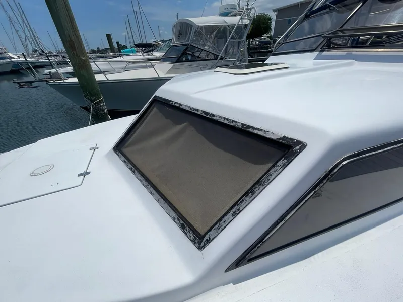 Slide: The Image of 1976 Allmand 25 Express Inboard boat docked at a marina. - 39