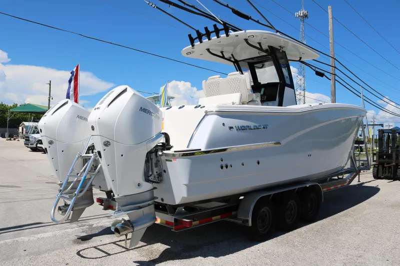 Slide: The Image of 2025 World Cat 280 CC-X boat on trailer with dual Mercury engines, parked outdoors. - 10