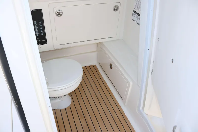Slide: The Image of 2025 World Cat 280 CC-X boat interior with toilet and wooden flooring. - 17