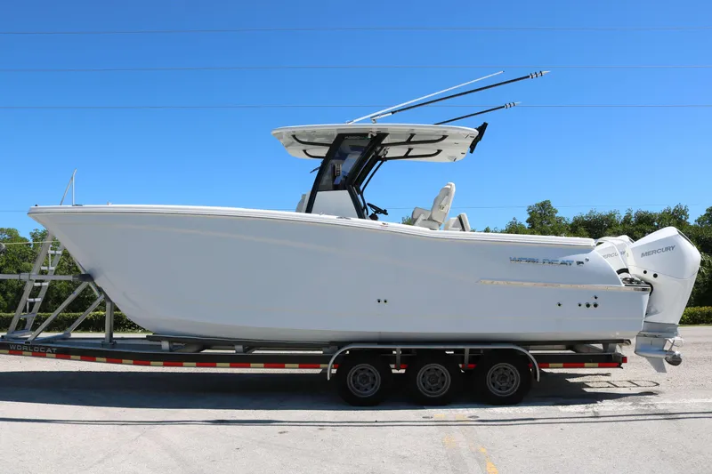 Slide: The Image of 2025 World Cat 280 CC-X boat on trailer, side view, clear blue sky. - 8