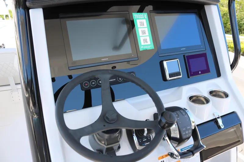 Slide: The Image of 2025 World Cat 280 CC-X boat dashboard with steering wheel and digital displays. - 13