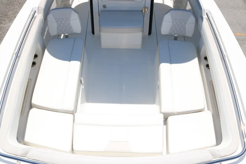 Slide: The Image of 2025 World Cat 280 CC-X boat interior with white cushioned seating. - 16