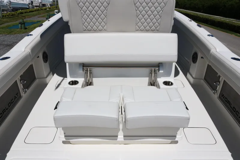 Slide: The Image of 2025 World Cat 280 CC-X boat interior with white cushioned seating and diamond stitching. - 18