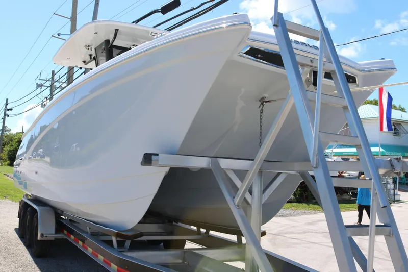 Slide: The Image of 2025 World Cat 280 CC-X boat on trailer, side view, sunny day. - 9