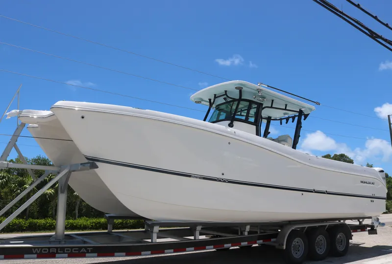 The Image of 2025 World Cat 325 CC boat on a trailer under a clear blue sky. - 0