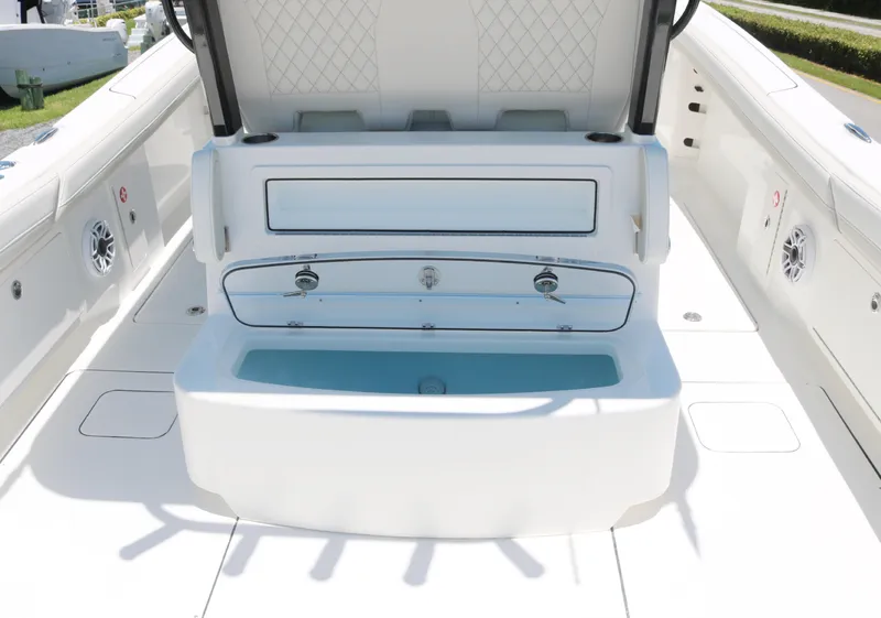 Slide: The Image of 2025 World Cat 325 CC boat interior with storage compartments and seating. - 10