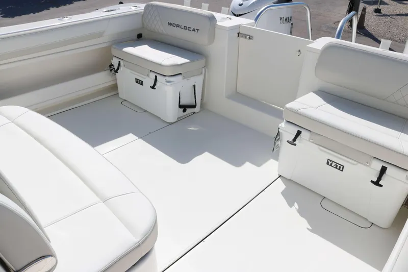 Slide: The Image of 2025 World Cat 325 CC boat interior with Yeti coolers and cushioned seating. - 11