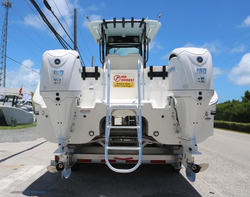 Slide: The Image of 2025 World Cat 325 CC boat with twin Yamaha 350 engines, rear view. - 4