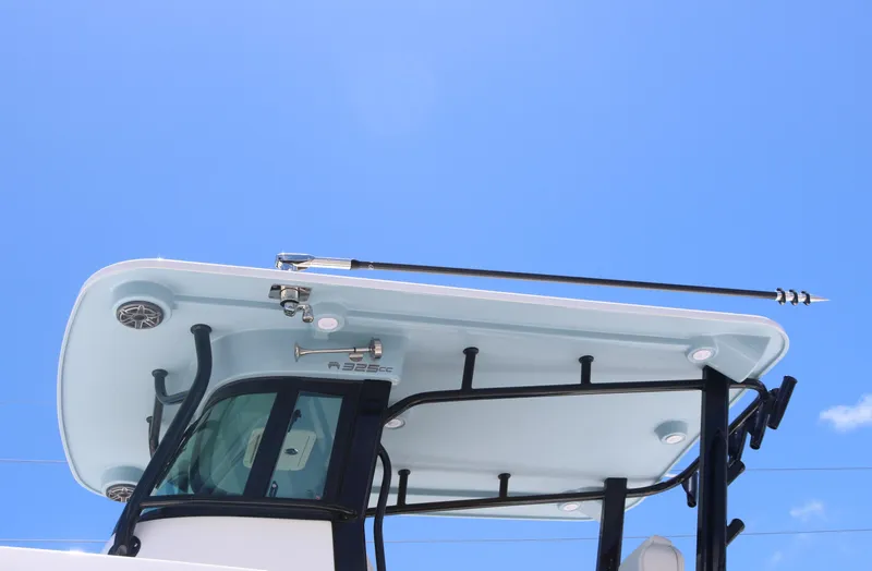 Slide: The Image of 2025 World Cat 325 CC boat hardtop against clear blue sky. - 5