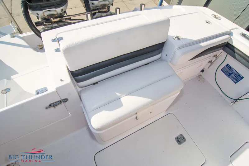 Slide: The Image of 2005 Donzi 32 ZF boat interior with white seating and storage compartments. - 15