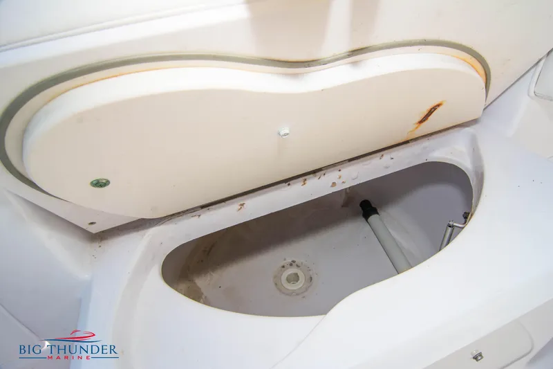 Slide: The Image of Open storage compartment on a 2005 Donzi 32 ZF boat with visible rust and dirt. - 16