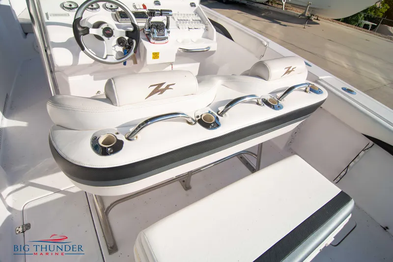 Slide: The Image of 2005 Donzi 32 ZF boat interior with white seating and control panel. - 22