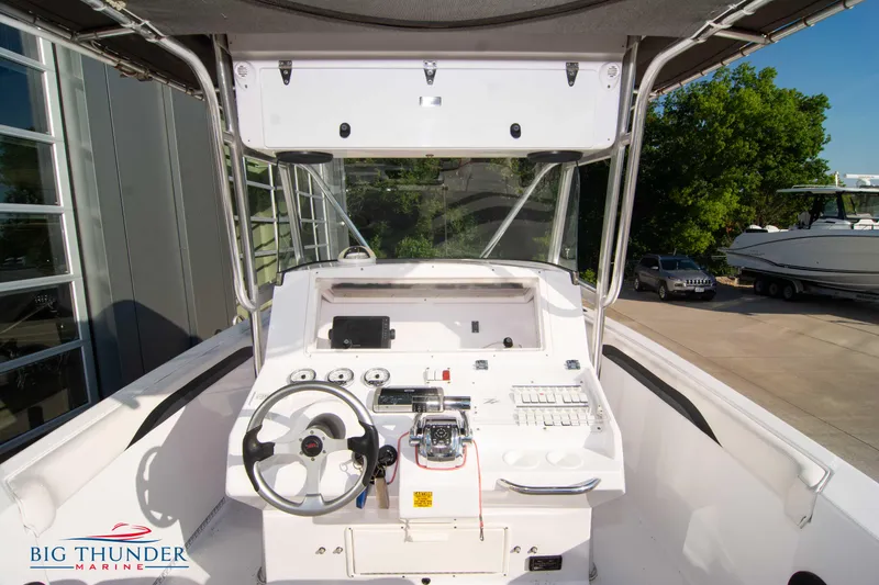 Slide: The Image of 2005 Donzi 32 ZF boat cockpit with steering wheel and control panel at Big Thunder Marine. - 25