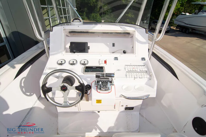 Slide: The Image of 2005 Donzi 32 ZF boat cockpit with steering wheel and control panel. - 26