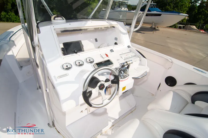 Slide: The Image of 2005 Donzi 32 ZF boat cockpit with steering wheel and control panel. - 28