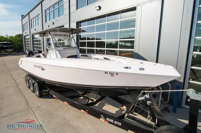 Slide: The Image of 2005 Donzi 32 ZF boat on a trailer outside Big Thunder Marine dealership. - 3